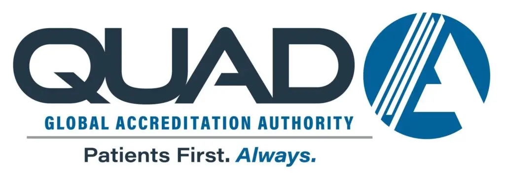 Logo for QUAD A Global Accreditation Authority, featuring bold text, a stylized “A” in a blue circle, and the tagline “Patients First. Always.”.
