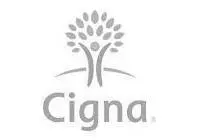 Gray Cigna logo featuring a stylized tree with a human figure at its center, and the word Cigna written below in a rounded font.
